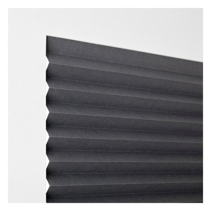 Black pleated blind on a white background
