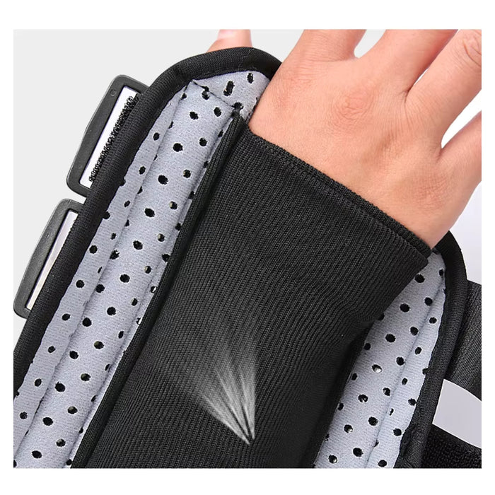 Black wrist support brace with a hand wearing it on a light gray background
