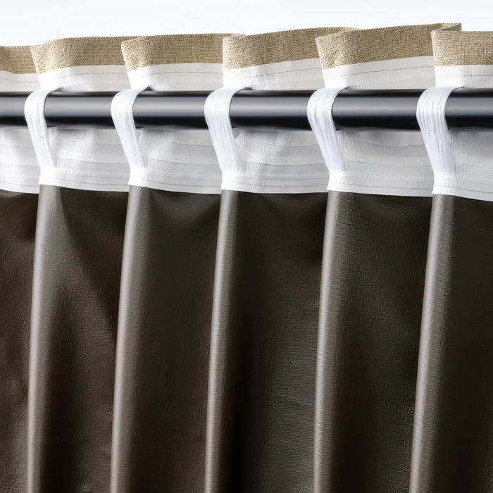 Brown curtains with white and beige trim on a rod