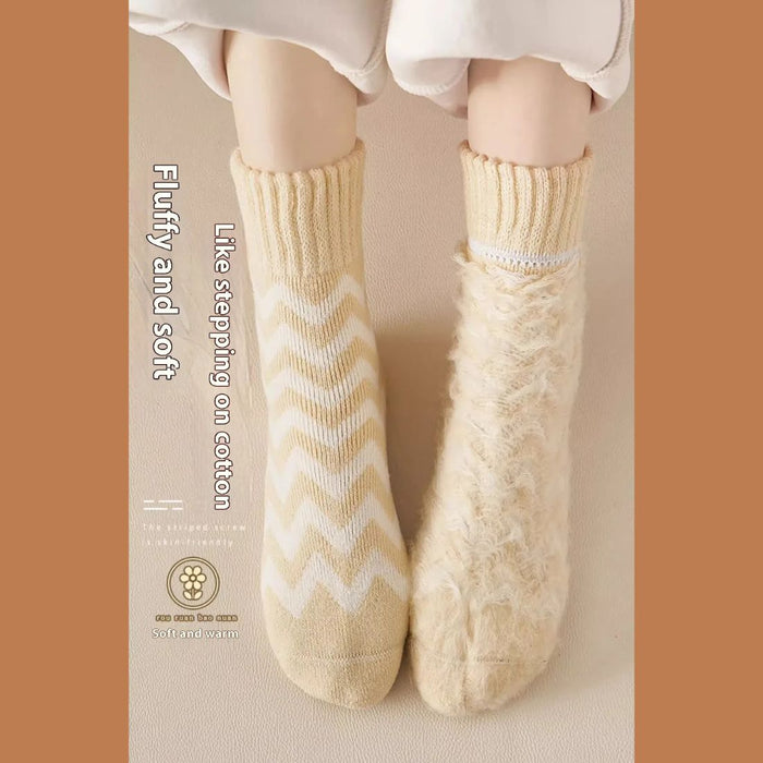 Feet wearing mismatched cozy socks—one zigzag, one fluffy—on soft beige background