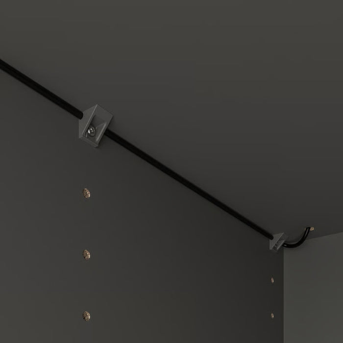 Ceiling track lighting system with fixtures on a dark ceiling