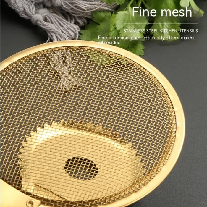 Golden stainless steel fine mesh strainer with a circular design and central drainage hole, set against a dark background. The utensil is labeled “STAINLESS STEEL KITCHEN UTENSILS – Fine oil draining net efficiently filters excess oil residue,” highlighting its precision mesh structure for oil separation. Accompanied by green leaves and a grey cloth, the image evokes an elegant and efficient kitchen environment -1600003112383 13034147.