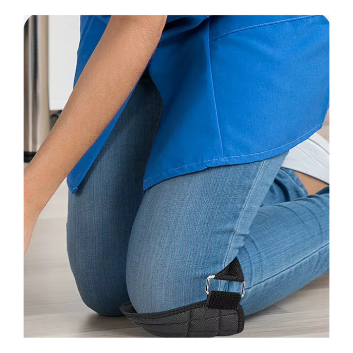 Person wearing blue pants with a black strap around the waist on a light wooden floor.