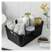 Black storage basket with bath products on a bathroom counter