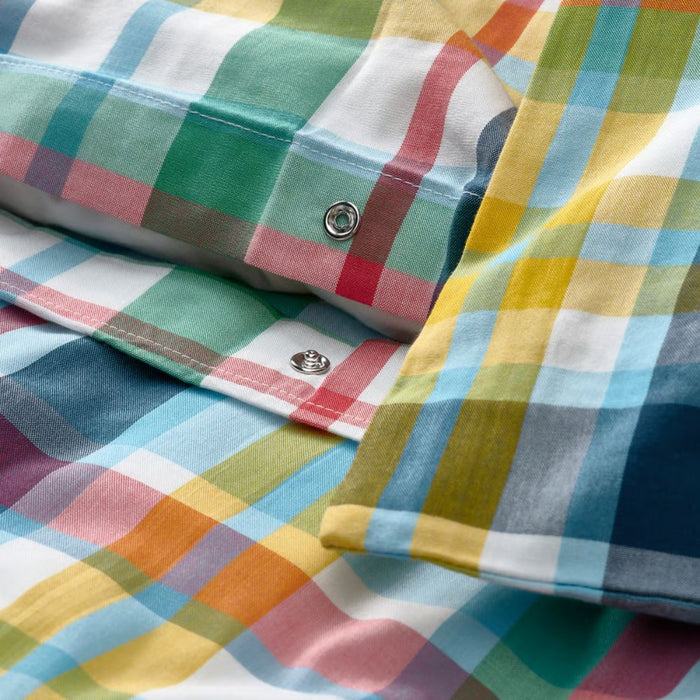 Close-up of a colorful plaid fabric with a button.