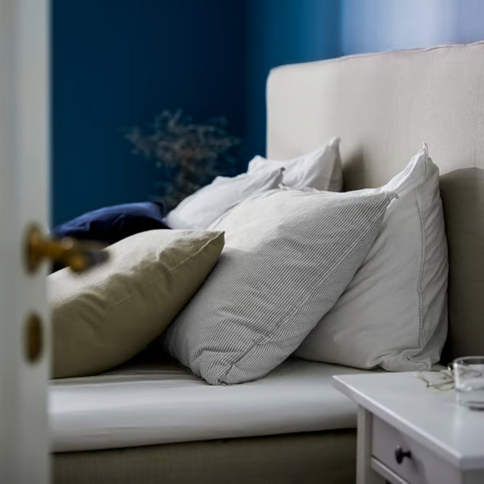 BERGPALM pillowcase, grey/striped, 50x80 cm. Shown on bed with beige headboard, white and blue pillows, and white nightstand – adds soft, relaxed charm to bedroom – 80577149.