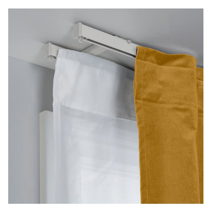 Curtain rod with white and mustard-colored curtains on a plain background