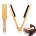 Two beige hairbrushes with black bristles on a white background, one of which is being used to brush hair.