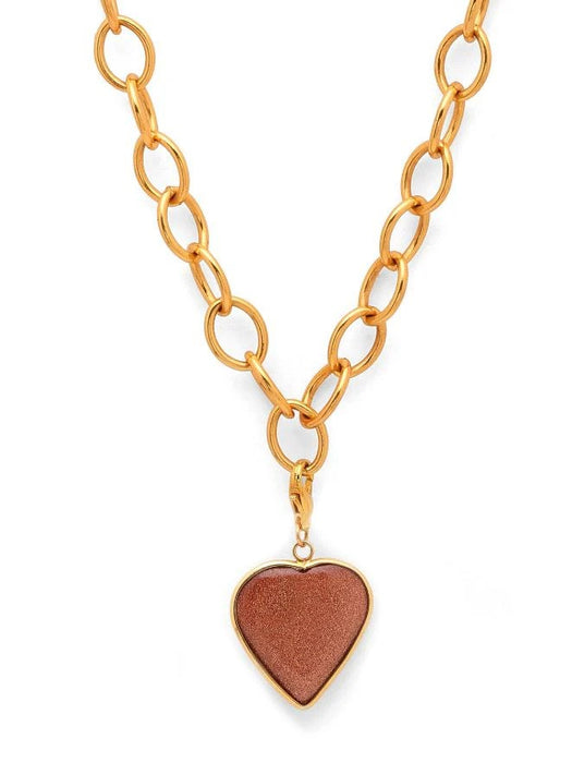 Gold chain necklace with a heart-shaped pendant on a white background