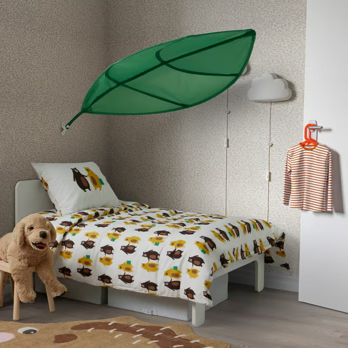 Child's room with green LÖVA bed canopy, bear pattern bedding and cloud decor