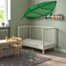 Nursery room setup with LÖVA bed canopy over a crib alongside soft toys