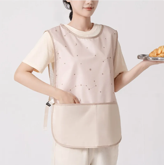 Person wearing a beige apron holding a tray with food on a plain background
