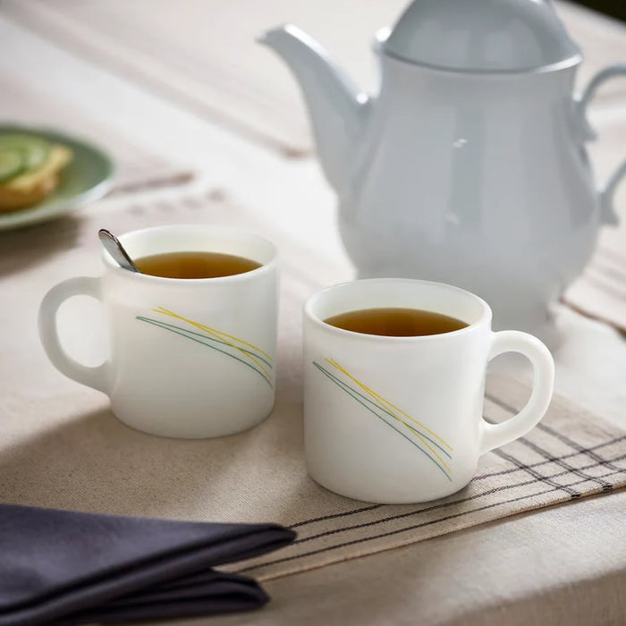 IKEA SKRÄNTÄRNA stripe cups with gold lines beside a grey kettle in a tea setting