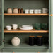 IKEA SKRÄNTÄRNA cups on a green kitchen cabinet shelf with bowls, plates, glasses and jars