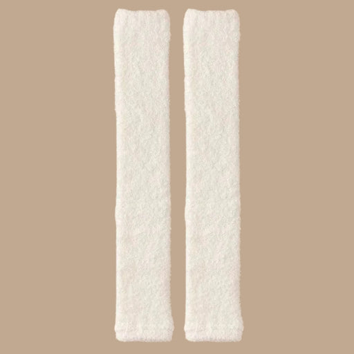 Pair of milky white plush leg warmers laid flat, showing soft texture and gathered ends - 
