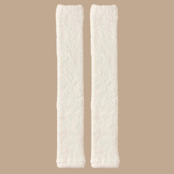 Pair of milky white plush leg warmers laid flat, showing soft texture and gathered ends - 