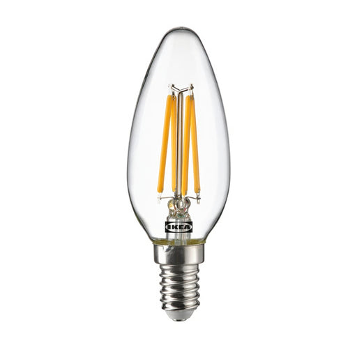 Clear LED candle bulb with visible IKEA logo on a white background