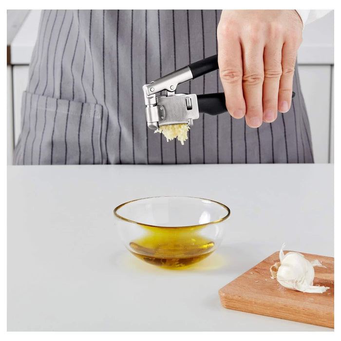 IKEA VÄRDEFULL black garlic press open flat showing chamber for easy cleaning