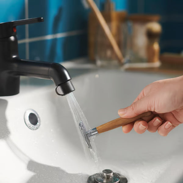 Chrome mixer tap with ÅBÄCKEN mist nozzle close-up sleek design on blue-tiled wall