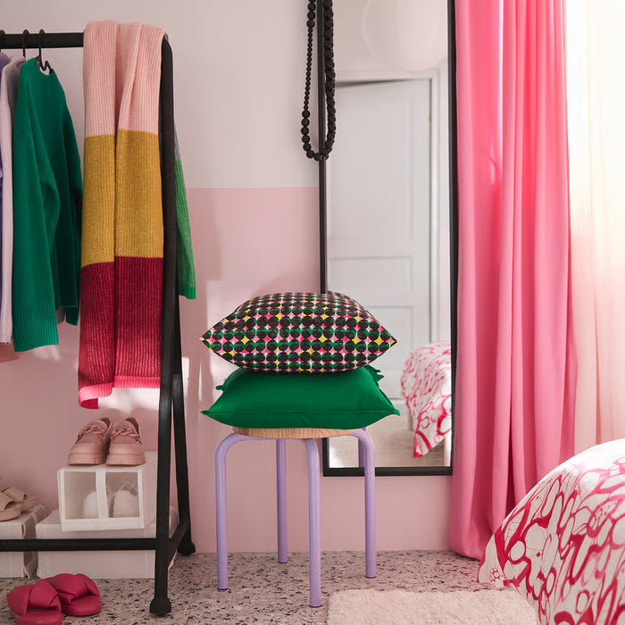 IKEA ÄLVSJÖSKOGEN cushion cover styled on a stool with pink curtains in the background