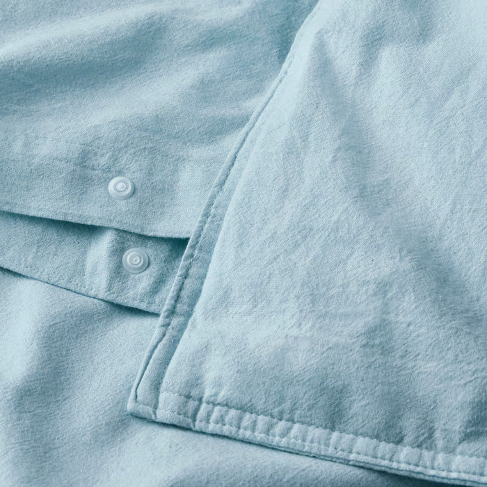 IKEA ÄNGSLILJA blue-grey duvet cover showing press-stud button closure detail