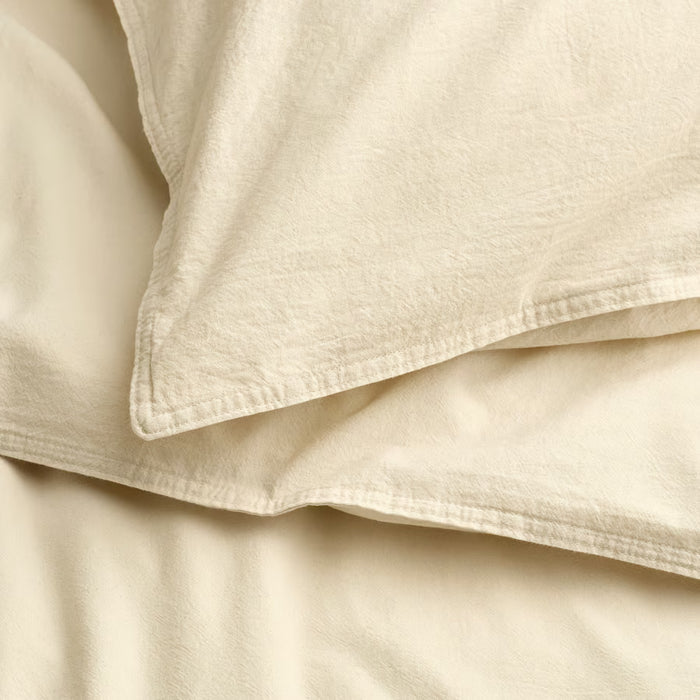 Folded IKEA ÄNGSLILJA cream duvet set showing envelope closure detail