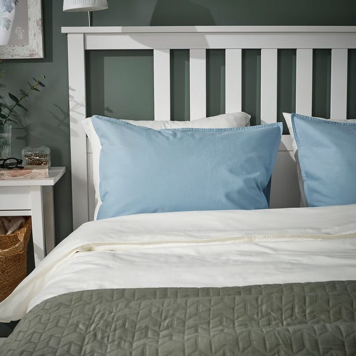 IKEA ÄNGSLILJA blue-grey pillowcases styled on bed in cosy bedroom headboard nook