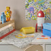 IKEA AFTONSPARV rocket lamp on children's desk with colouring mat and toys