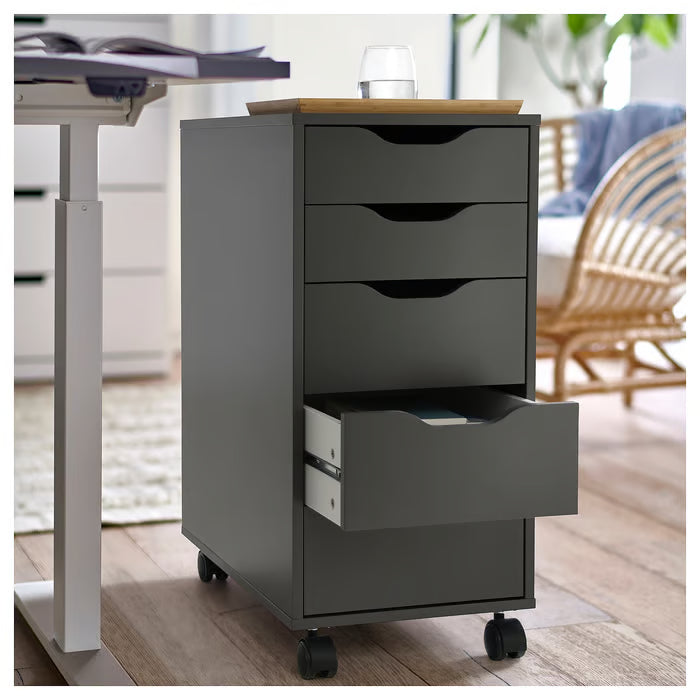 Grey IKEA ALEX four-drawer unit on black castors beside a white home office desk