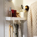 IKEA ALTARLIDEN white wall hook rack holding necklaces with shelf displaying beauty products