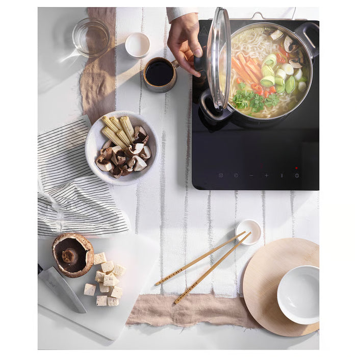 IKEA ANNONS pot simmering vegetables mushrooms and tofu on induction hob with chopsticks