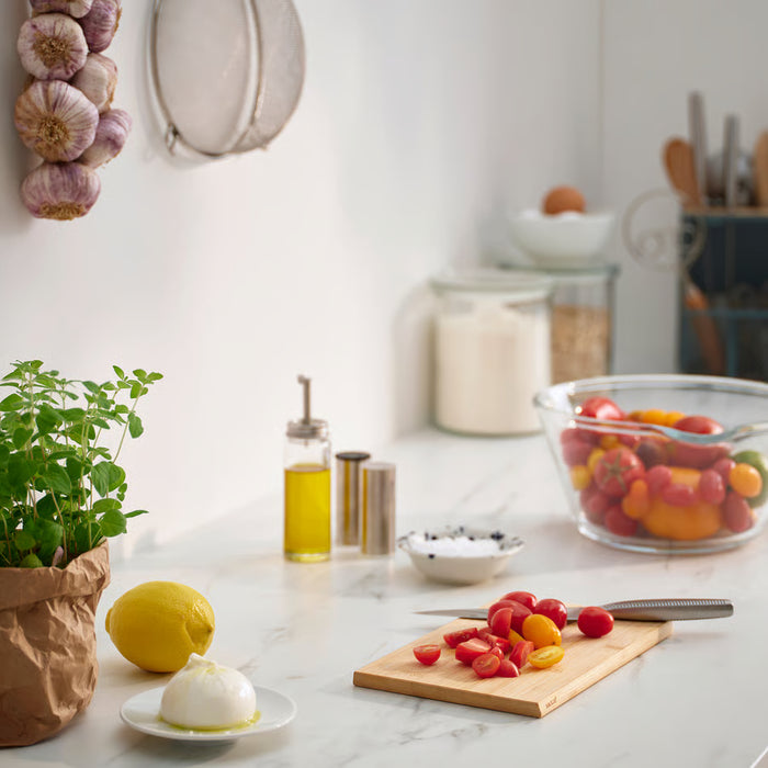  IKEA APTITLIG bamboo chopping board with fresh tomatoes on marble kitchen counter