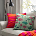 IKEA AROMATISK green cushion cover, 50x50 cm (20x20"), displayed on a sofa.70588997        
