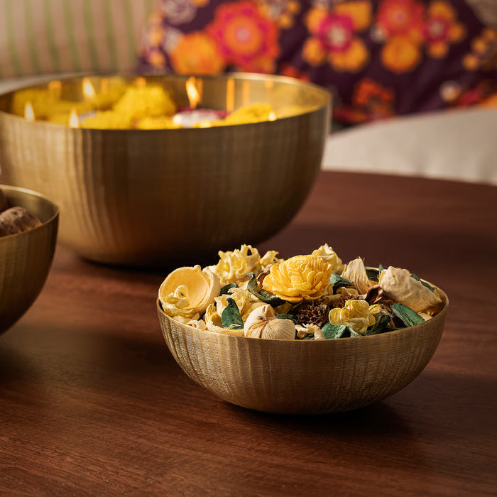 : IKEA AROMATISK gold bowl styled with fresh flowers and floating candles
