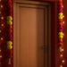 IKEA AROMATISK paper flower garland decorating a wooden door for festive décor