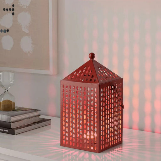 "Aromatisk Lantern, 30 cm, with a candle inside, creating ambient lighting in a cozy living room-90541876
