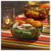 IKEA AROMATISK green glass bowl filled with colourful candies on red striped tablecloth with candle