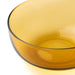 Close-up of IKEA AROMATISK amber yellow glass bowl showing smooth edges and reflective handcrafted surface