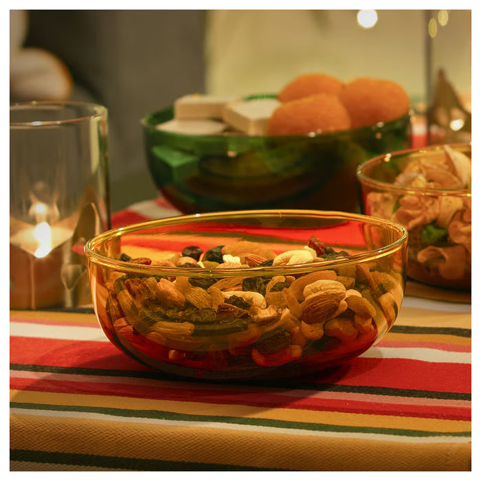 IKEA AROMATISK glass bowls styled with dried fruits, nuts and lit candle on festive striped cloth