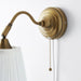 IKEA ÅRSTID brass wall lamp side view showing adjustable arm and pull chain with white shade