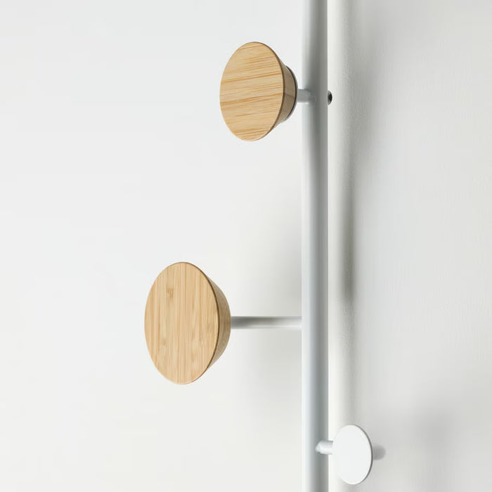 Close-up of BÄRFIS wooden knobs on metal rail mounted on a bedroom door