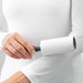 Hand holding IKEA BÄSTIS lint roller removing fuzz from white fabric close-up view