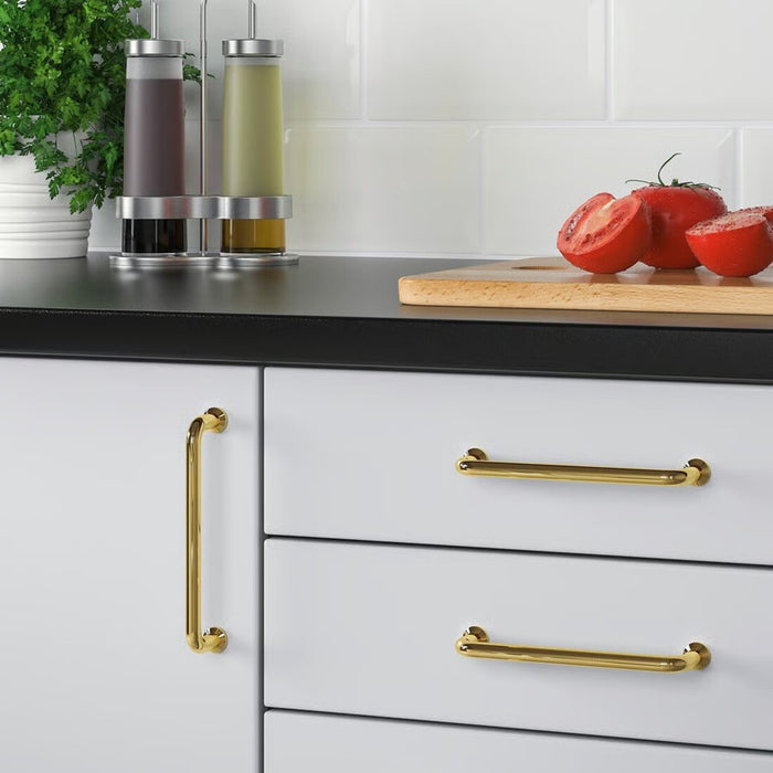 Kitchen cabinet with gold handles on a white background