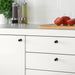 "IKEA BAGGANÄS knob with a simple round design on a classic wooden cabinet-40338429