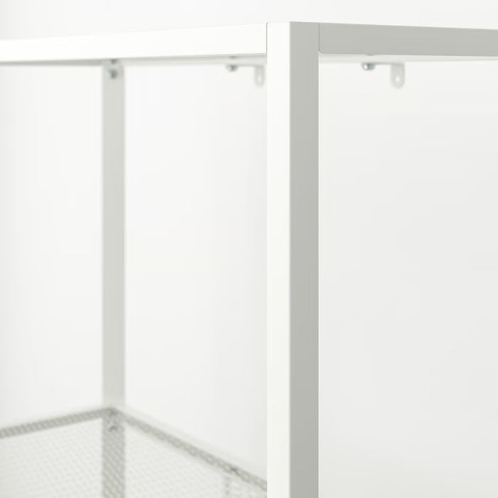 Close-up of IKEA BAGGEBO white metal frame and mesh shelf detailing sleek minimalist finish