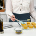  IKEA BAKGLAD light blue silicone pastry brush coating round cookies with yellow liquid on silver baking tray
