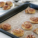 IKEA BAKTRADITION baking mat with freshly baked golden-brown cinnamon rolls on dark baking tray