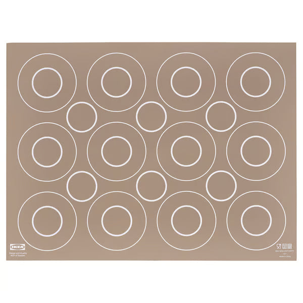 IKEA BAKTRADITION beige silicone baking mat 41x31cm with circular portion guides, flat lay on surface #50480177