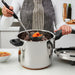 Person serving cooked vegetables from IKEA BANDGURAMI pressure cooker with a ladle