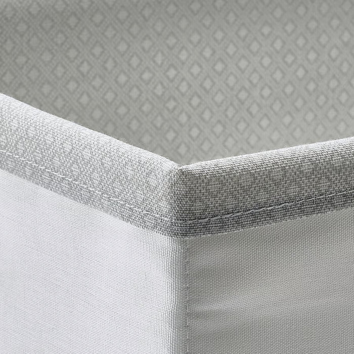 Close-up of IKEA BAXNA grey fabric organiser corner showing textured recycled polyester weave
